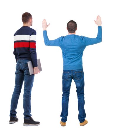 Back view two man in sweater with laptop. Rear view people collection. backside view of person. Isolated over white background. Guys looking forwardの写真素材