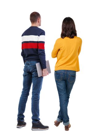 Back view couple with laptop in sweater. beautiful man and woman. Rear view people collection. backside view of person. Isolated over white background.の写真素材