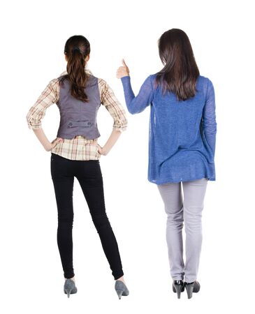 Back view of two woman in sweater showing thumb up. Rear view people collection. backside view of person. Rear view. Isolated over white background.の写真素材