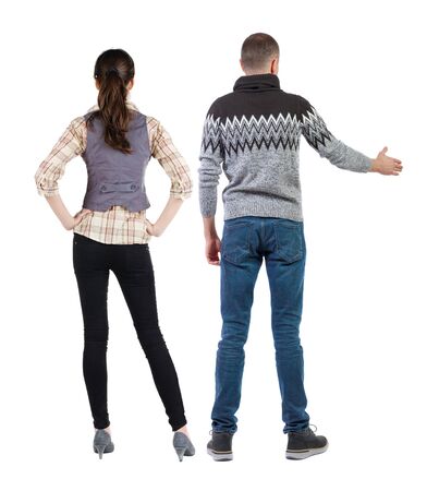 Back view of couple in sweater pointing. Rear view people collection. backside view of person. Isolated over white background.の写真素材