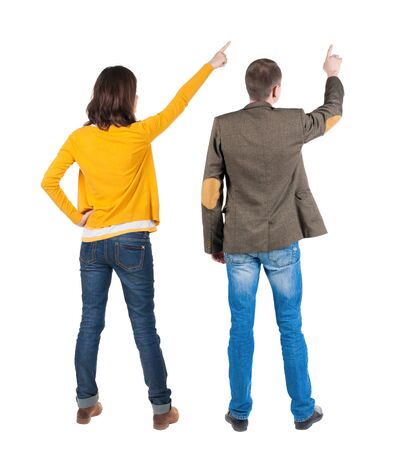 Back view of couple in sweater pointing. Rear view people collection. backside view of person. Isolated over white background.の写真素材