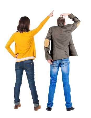Back view of couple in sweater pointing. Rear view people collection. backside view of person. Isolated over white background.の写真素材