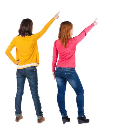 Back view of two pointing girl in sweater. Rear view people collection. backside view of person. beautiful woman showing gesture. Rear view. Isolated over white background.の写真素材