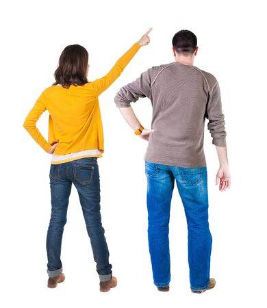 Back view of couple in sweater pointing. Rear view people collection. backside view of person. Isolated over white background.の写真素材