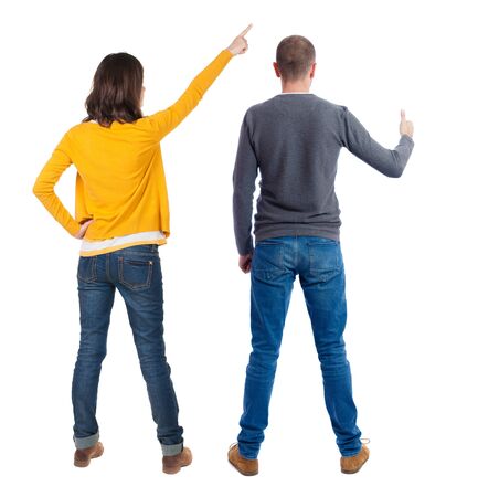 Back view of couple in sweater pointing. Rear view people collection. backside view of person. Isolated over white background.の写真素材