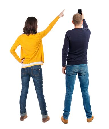 Back view of couple in sweater with mobile phone. Rear view people collection. backside view of person. Isolated over white background.の写真素材