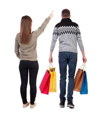 back view of couple with shopping bags. backside view of person. Rear view people collection. Isolated over white background.の写真素材