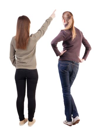 Back view of two pointing girl in sweater. Rear view people collection. backside view of person. beautiful woman showing gesture. Rear view. Isolated over white background.の写真素材