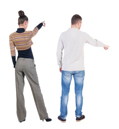 Back view of couple in sweater pointing. Rear view people collection. backside view of person. Isolated over white background.の写真素材