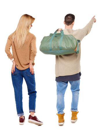 Back view of couple in sweater pointing. Rear view people collection. backside view of person. Isolated over white background.の写真素材