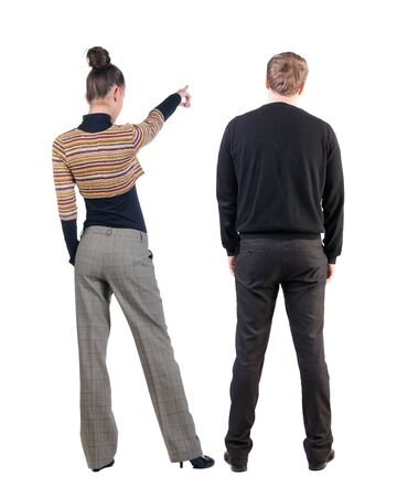 Back view of couple in sweater pointing. Rear view people collection. backside view of person. Isolated over white background.の写真素材