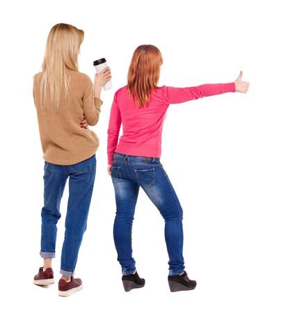 Back view of two woman in sweater showing thumb up. Rear view people collection. backside view of person. Rear view. Isolated over white background.の写真素材