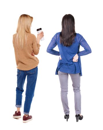 Back view of two woman in sweater. Rear view people collection. backside view of person. Isolated over white background. Girls are looking forwardの写真素材