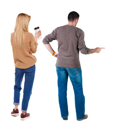 Back view of couple in sweater pointing. Rear view people collection. backside view of person. Isolated over white background.の写真素材