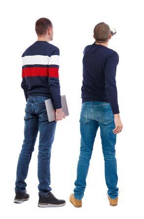 Back view two man in sweater with laptop. Rear view people collection. backside view of person. Isolated over white background. Guys looking forwardの写真素材