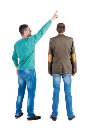Back view of two man in sweater pointing. Rear view people collection. backside view of person. Isolated over white background. Guys stare aheadの写真素材