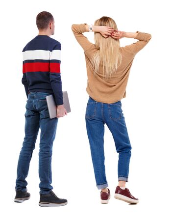 Back view couple with laptop in sweater. beautiful man and woman. Rear view people collection. backside view of person. Isolated over white background.の写真素材