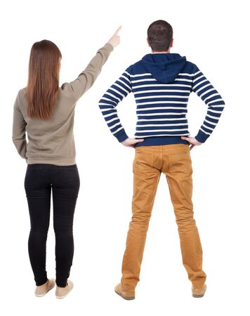 Back view of couple in sweater pointing. Rear view people collection. backside view of person. Isolated over white background.の写真素材