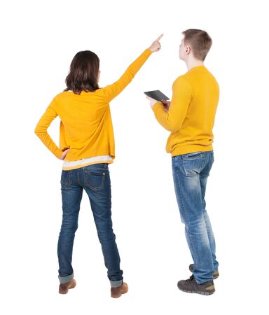 Back view of couple in sweater with mobile phone. beautiful friendly girl and guy together. Rear view people collection. backside view of person. Isolated over white background.の写真素材