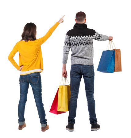 back view of couple with shopping bags. backside view of person. Rear view people collection. Isolated over white background.の写真素材