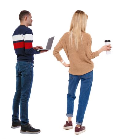 Back view couple with laptop in sweater. beautiful man and woman. Rear view people collection. backside view of person. Isolated over white background.の写真素材