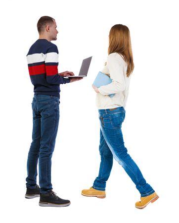Back view couple with laptop in sweater. beautiful man and woman. Rear view people collection. backside view of person. Isolated over white background.の写真素材