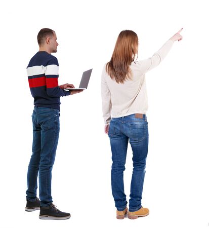 Back view couple with laptop in sweater. beautiful man and woman. Rear view people collection. backside view of person. Isolated over white background.の写真素材