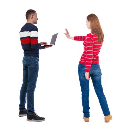 Back view couple with laptop in sweater. beautiful man and woman. Rear view people collection. backside view of person. Isolated over white background.の写真素材