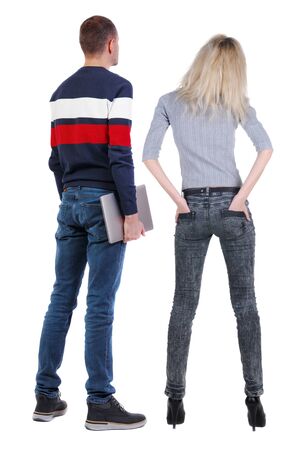 Back view couple with laptop in sweater. beautiful man and woman. Rear view people collection. backside view of person. Isolated over white background.の写真素材