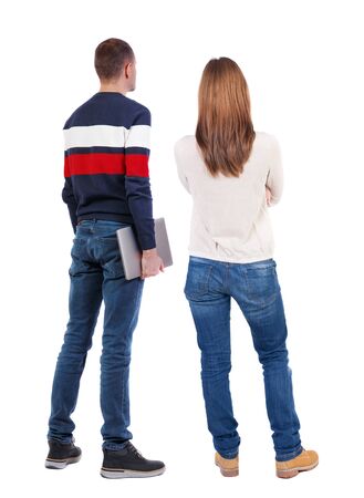 Back view couple with laptop in sweater. beautiful man and woman. Rear view people collection. backside view of person. Isolated over white background.の写真素材