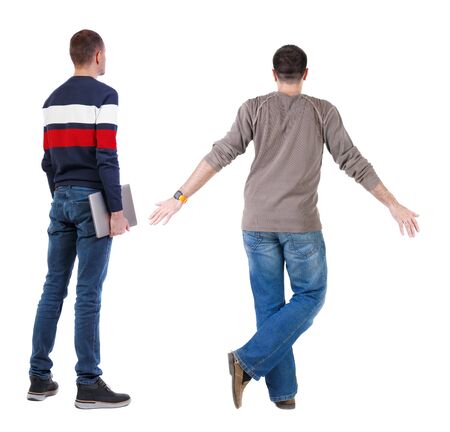 Back view two man in sweater with laptop. Rear view people collection. backside view of person. Isolated over white background. Guys looking forwardの写真素材