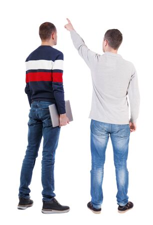 Back view two man in sweater with laptop. Rear view people collection. backside view of person. Isolated over white background. Guys looking forwardの写真素材