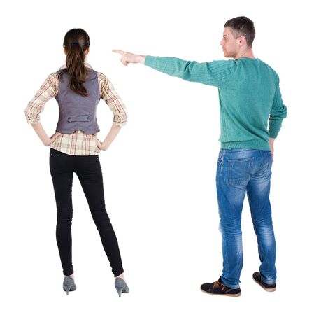 Back view of couple in sweater pointing. Rear view people collection. backside view of person. Isolated over white background.の写真素材