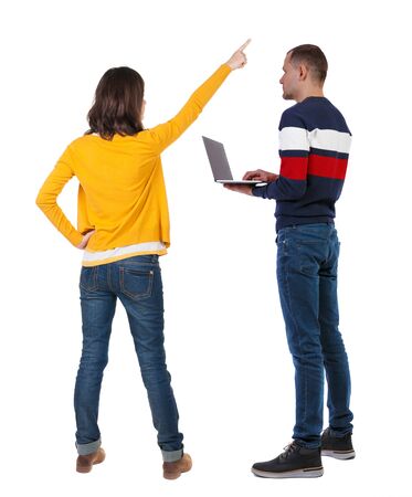 Back view couple with laptop in sweater. beautiful man and woman. Rear view people collection. backside view of person. Isolated over white background.の写真素材