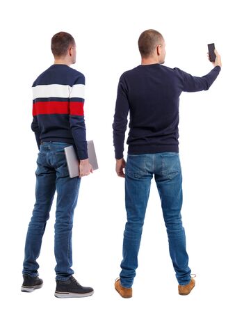 Back view two man in sweater with laptop. Rear view people collection. backside view of person. Isolated over white background. Guys looking forwardの写真素材