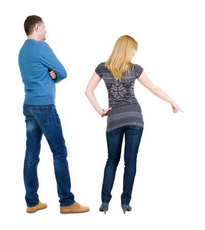 Back view of couple in sweater pointing. Rear view people collection. backside view of person. Isolated over white background.の写真素材