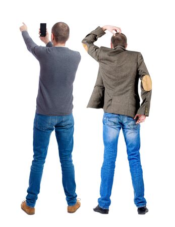 Back view of two man in sweater with mobile phone. Rear view people collection. backside view of person. Isolated over white background.の写真素材
