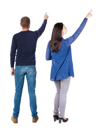 Back view of couple in sweater pointing. Rear view people collection. backside view of person. Isolated over white background.の写真素材