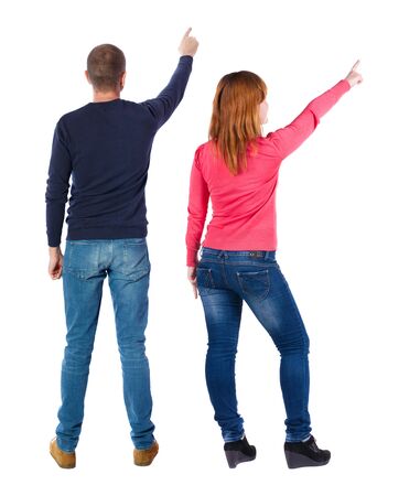 Back view of couple in sweater pointing. Rear view people collection. backside view of person. Isolated over white background.の写真素材