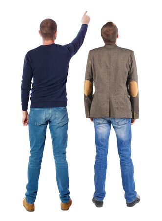 Back view of two man in sweater pointing. Rear view people collection. backside view of person. Isolated over white background. Guys stare aheadの写真素材