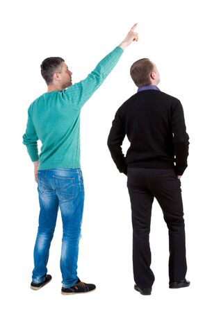 Back view of two man in sweater pointing. Rear view people collection. backside view of person. Isolated over white background. Guys stare aheadの写真素材