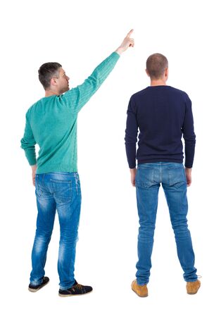 Back view of two man in sweater pointing. Rear view people collection. backside view of person. Isolated over white background. Guys stare aheadの写真素材