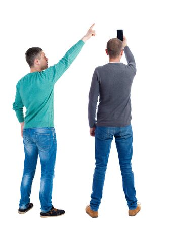Back view of two man in sweater with mobile phone. Rear view people collection. backside view of person. Isolated over white background.の写真素材