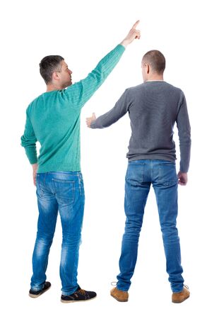 Back view of two man in sweater pointing. Rear view people collection. backside view of person. Isolated over white background. Guys stare aheadの写真素材