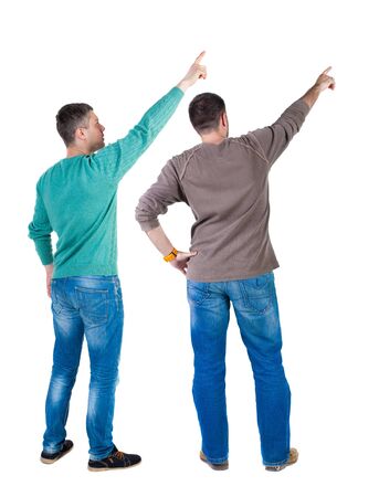 Back view of two man in sweater pointing. Rear view people collection. backside view of person. Isolated over white background. Guys stare aheadの写真素材