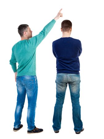 Back view of two man in sweater pointing. Rear view people collection. backside view of person. Isolated over white background. Guys stare aheadの写真素材