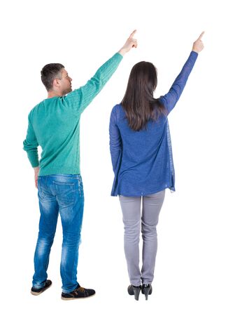 Back view of couple in sweater pointing. Rear view people collection. backside view of person. Isolated over white background.の写真素材