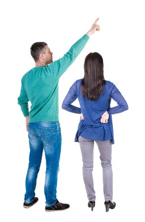 Back view of couple in sweater pointing. Rear view people collection. backside view of person. Isolated over white background.の写真素材