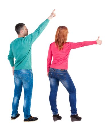 Back view of couple in sweater pointing. Rear view people collection. backside view of person. Isolated over white background.の写真素材