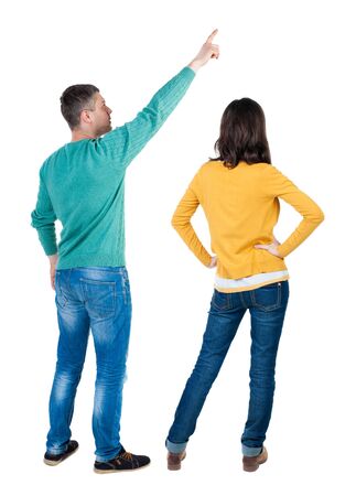 Back view of couple in sweater pointing. Rear view people collection. backside view of person. Isolated over white background.の写真素材